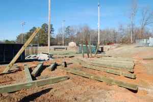 The 8"x8" Treated Posts Have Been Laid Next To Their Holes And Are Beginning To Be Raised
